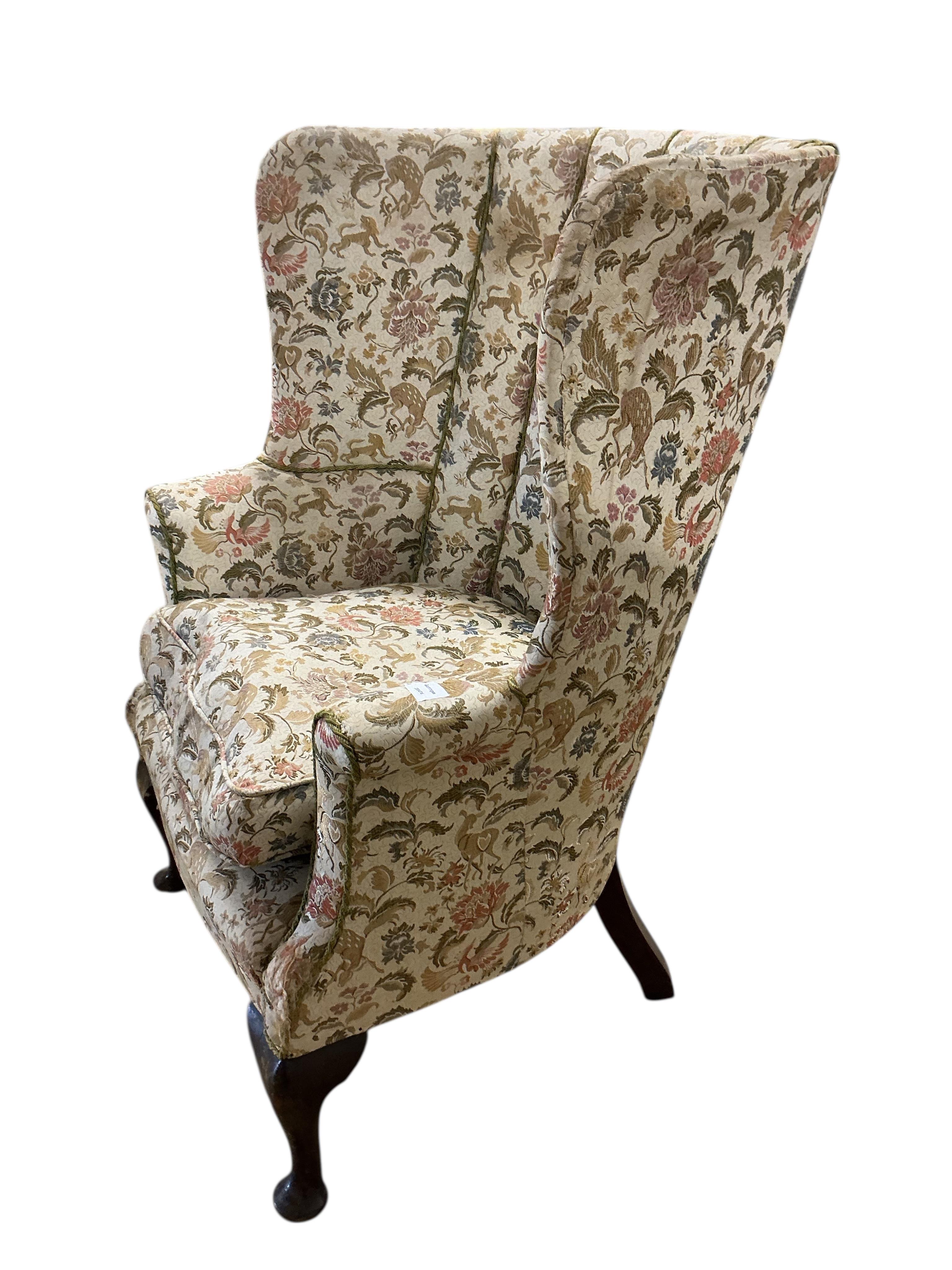 A George II style upholstered barrel-back wing armchair, width 80cm, depth 62cm, height 110cm
